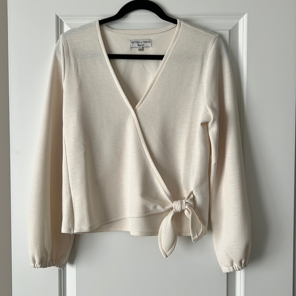 Madewell blouse with decorative bow and button closure.